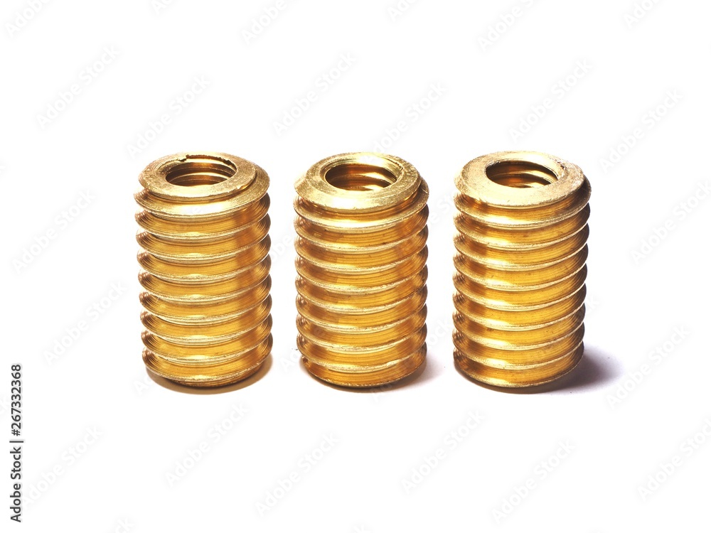 Screw made of brass for repairing damaged screw holes. On a white background. Screw made of brass for repairing damaged screw holes. On a white background.