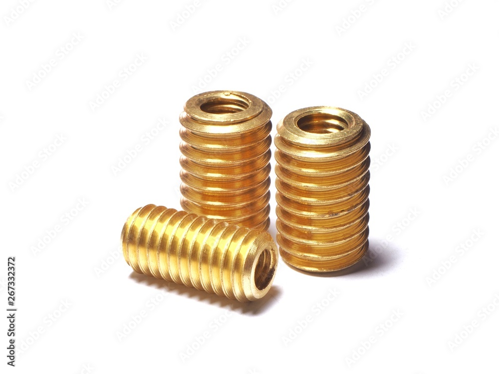 Screw made of brass for repairing damaged screw holes. On a white background. Screw made of brass for repairing damaged screw holes. On a white background.