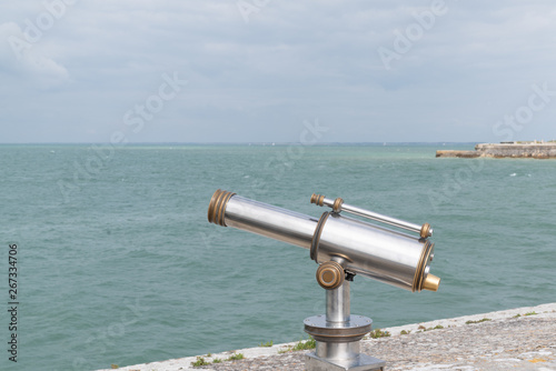 vintage coin operated binoculars for tourist viewer looking sea coast ocean
