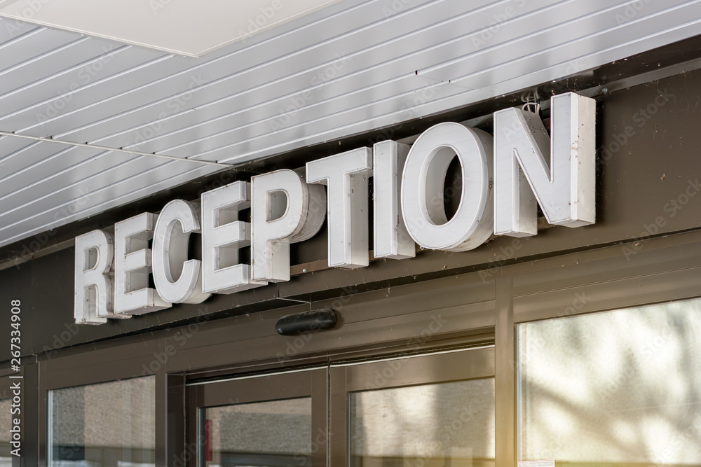 Obraz premium Reception inscription over door of hotel entrance, side view