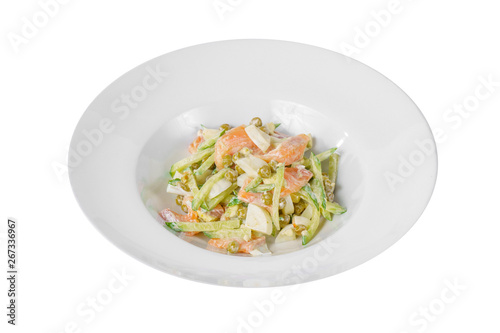 Russian salad with fish salmon, cucumber, peas, eggs, mayonnaise on plate, white isolated background, side view