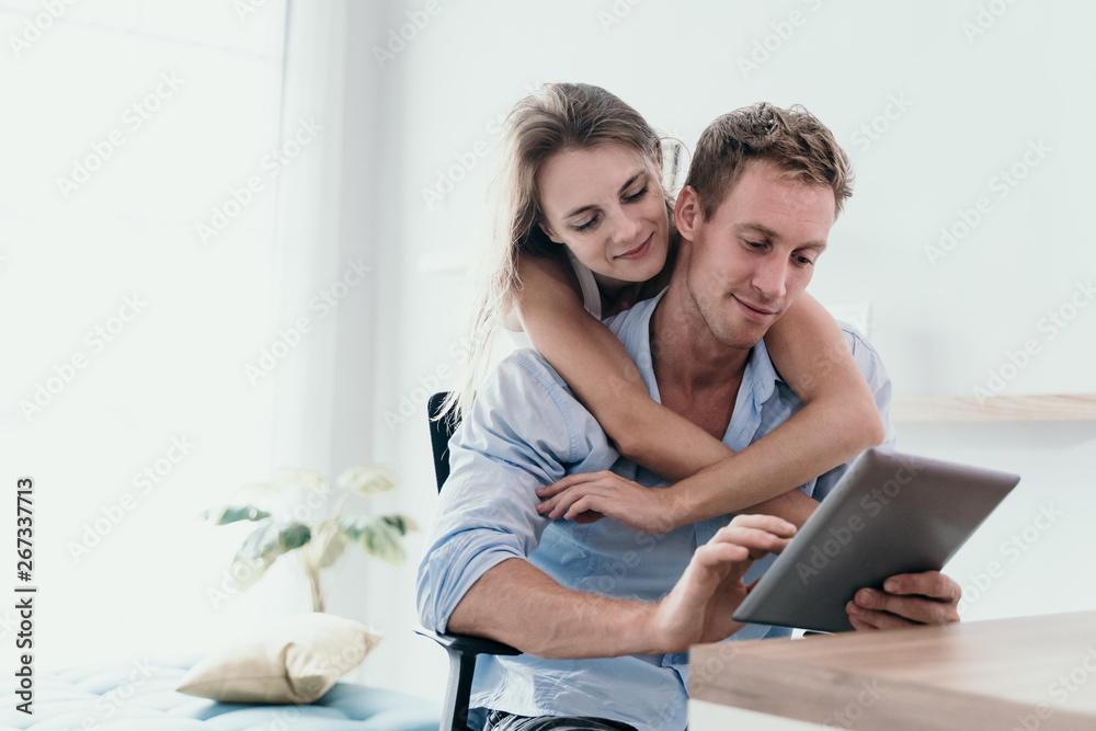 Couple love surfing with digital tablet on the internet in the morning