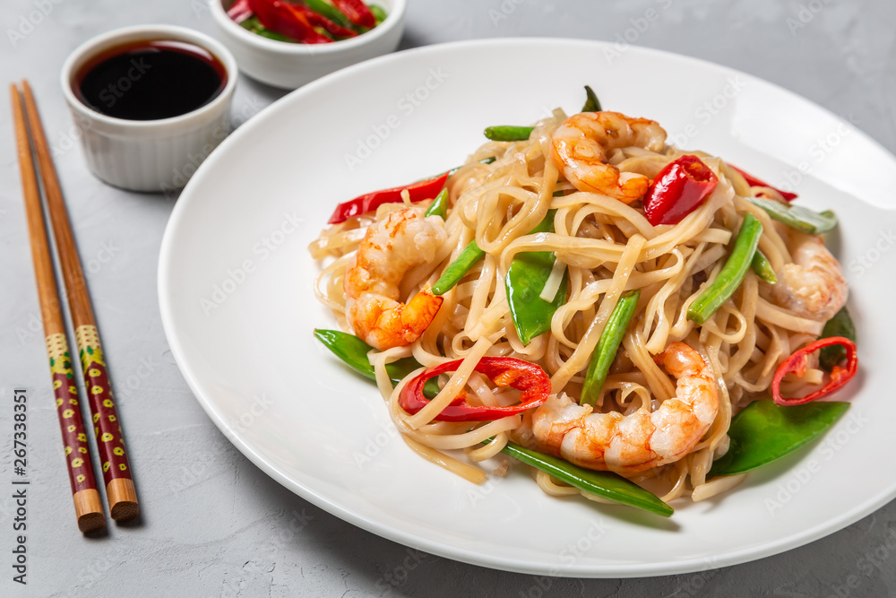 Asian dish of fried rice noodles with shrimp and vegetables