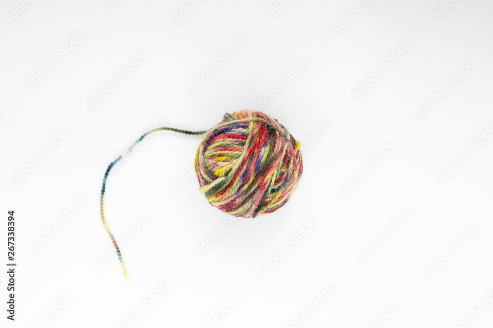 Multicolor ball of yarn on a light background. Close-up. Copy space Multicolor ball of yarn on a light background. Close-up. Copy space