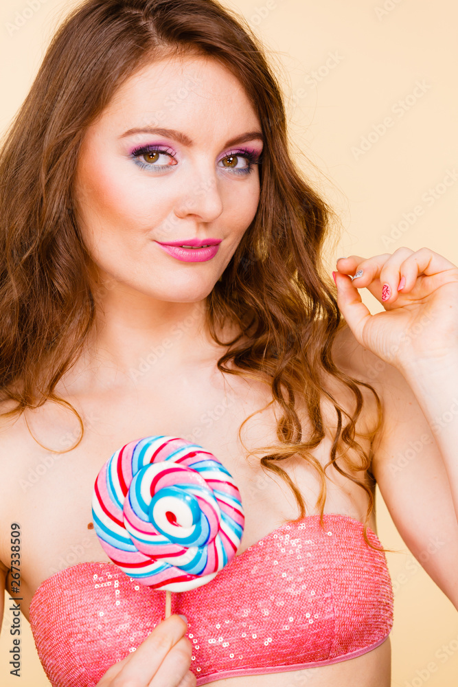 Woman holding colorful lollipop candy in hand. Woman holding colorful lollipop candy in hand.