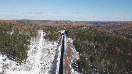 Winter day Aerial drone follow Trans-Siberian railway passengers tourist train near Baikal lake. Cinematic professional footage. High altitude photo