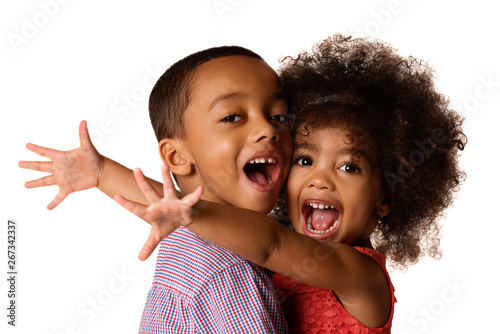 Two cheerful african-american siblings, sister hugging her brother, isolated