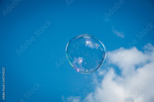 one round soap bubble on the blue sky