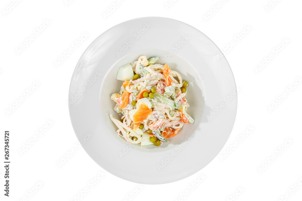 Russian salad with fish salmon, cucumber, peas, eggs, mayonnaise on plate, white isolated background, view from above Russian salad with fish salmon, cucumber, peas, eggs, mayonnaise on plate, white isolated background, view from above