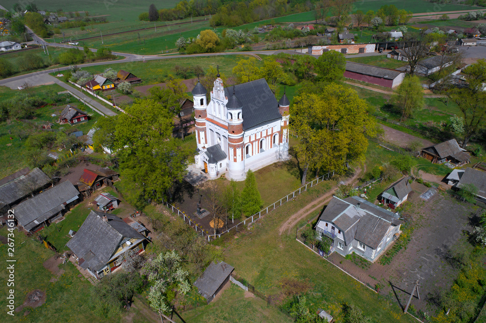 View of the defensive type church in the village of Murovanka on a sunny April day (aerial photography). Grodno region, Belarus