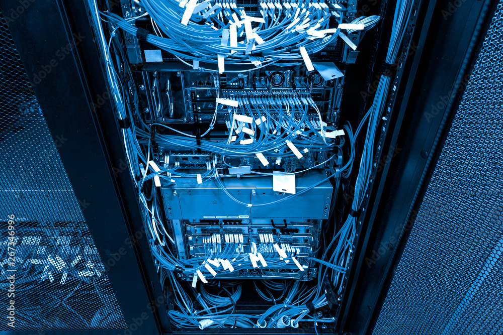 Network hub and patch UTP LAN cables in rack cabinet with dark cold blue  toning Stock-Foto | Adobe Stock