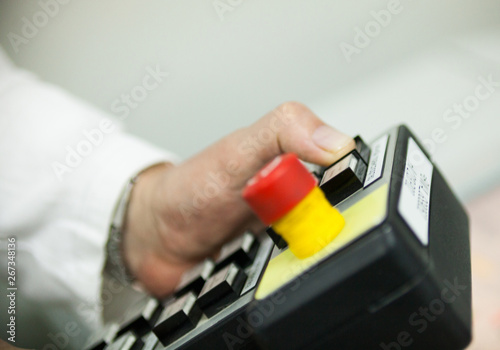Hand pushing the button on the control panel