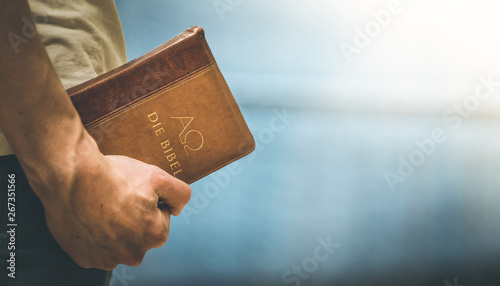 Photos Christian preacher: Young man is holding the bible, praying