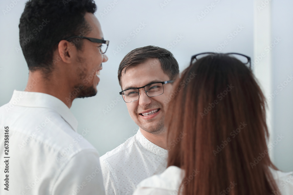 close up. business colleagues standing in a bright office close up. business colleagues standing in a bright office