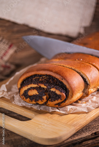 Poppy seeds roll  homemade cake on rustic wooden background