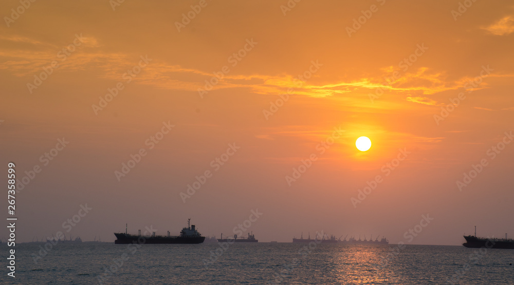 sunset sky or dawn shines in yellow, natural yellow and sea boats in the sea or lake. Warm color background