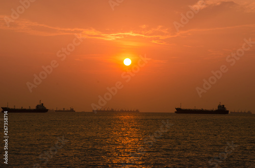  sunset sky or dawn shines in pink, natural pink and sea boats in the sea or lake. Warm color background