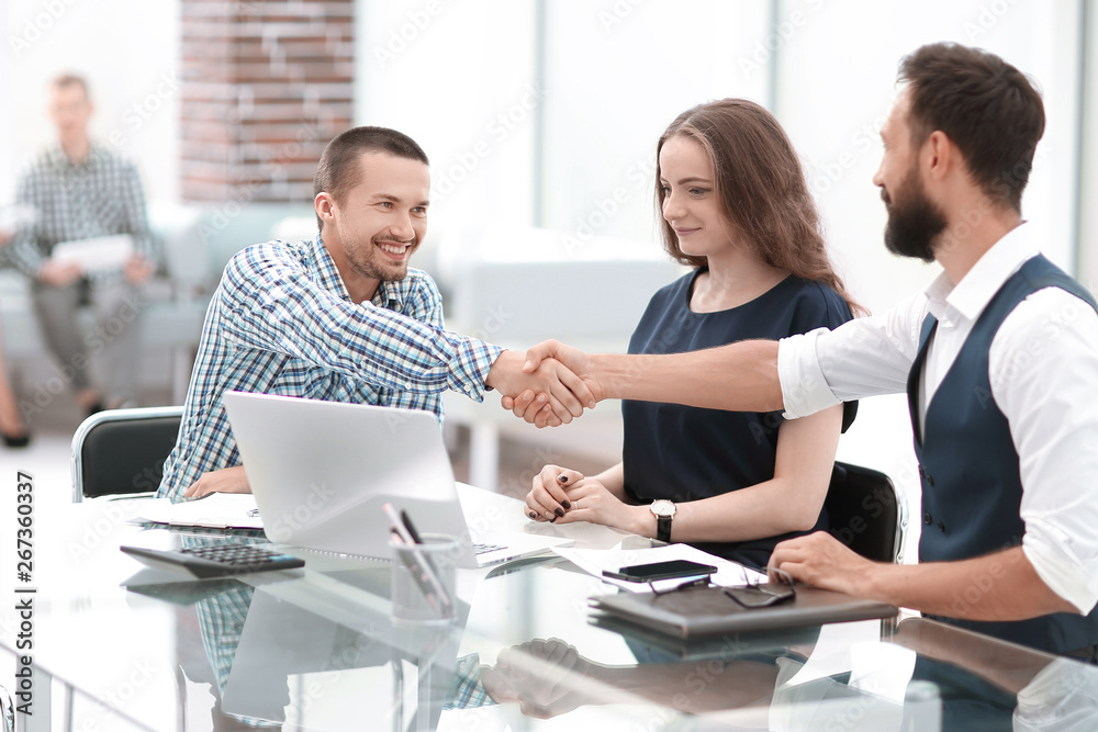 handshake business people sitting at the office Desk. handshake business people sitting at the office Desk.