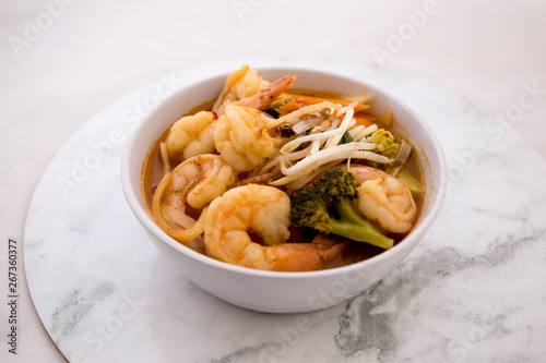 Tom Yam kung Spicy Thai soup in bowl