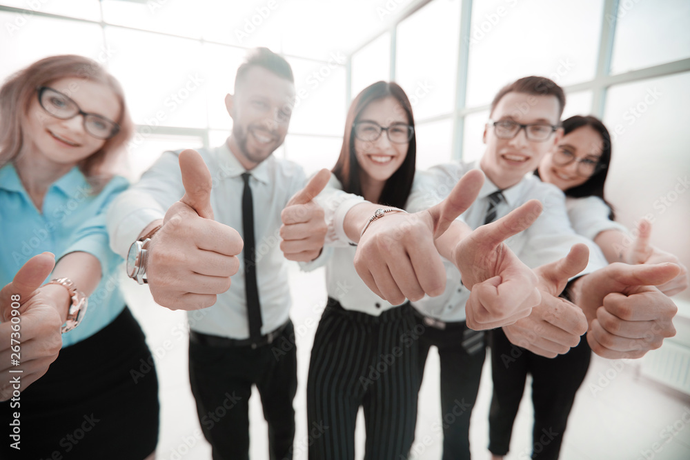 close up. business team showing their thumbs up close up. business team showing their thumbs up