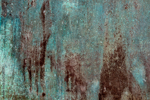 Ancient wall texture with patina or copper oxide stains. Grunge rusty background. Antique surface structure photo