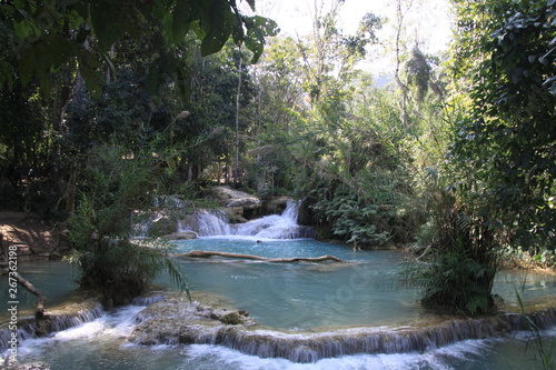 Scenic view on cascades and natural blue pool of idyllic Kuang Si waterfalls in jungle near Luang Prabang, Laos