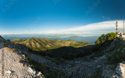 Panoramic view from the top of Mount Pantokrator, the highest mountain of Corfu with clear blue sky during evening (Corfu, Greece, Europe)