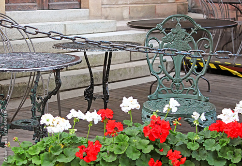 Wallpaper Mural Table, chair and geranium flowers in cafe in Stokholm, Sweden Torontodigital.ca