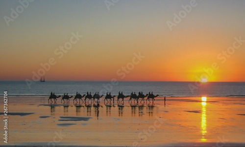 Sunset with silhouettes of a camel train on Cable Beach, Western Australia