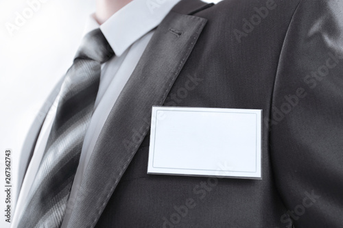 Obraz na płótnie Blank identity tag hanging from a businessmans suit w salonie