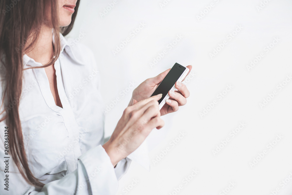 close up.business woman is typing SMS on mobile phone
