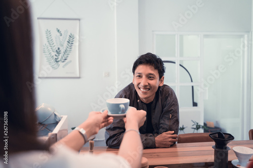asian male customer served with a cup of coffee in cafe