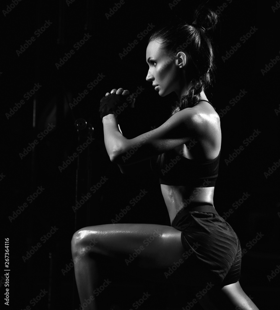 Sporty young woman working out with dumbbells weight in Gym. Diet and weight loss concept