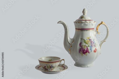 Decorative porcelain coffee set - coffee pot and cup. decorated with flowers in spanish style