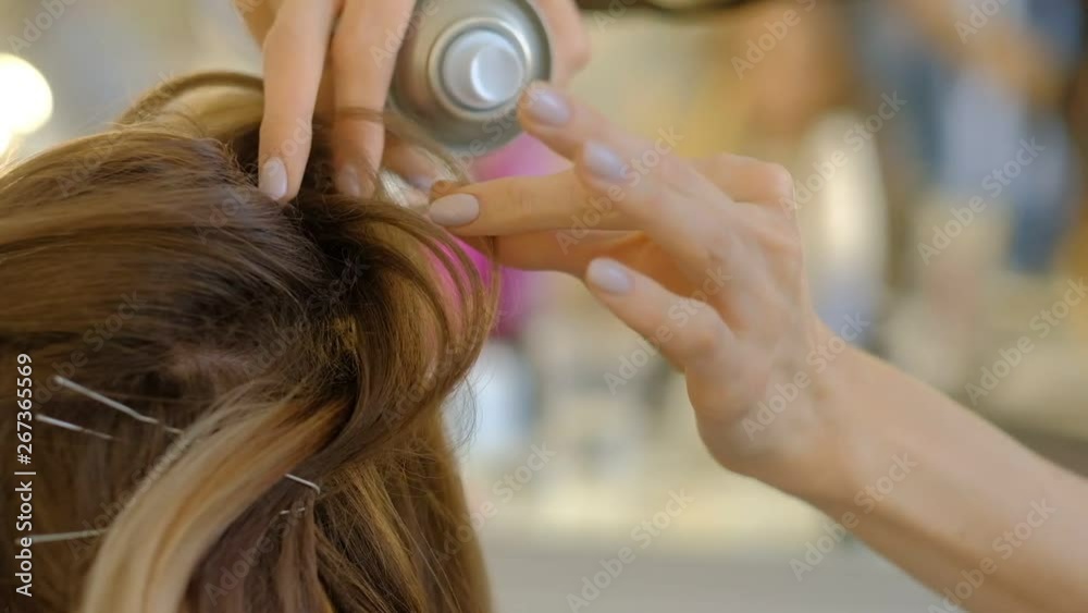 Master making hairstyle a girl at the beauty salon. slow motion Master making hairstyle a girl at the beauty salon. slow motion