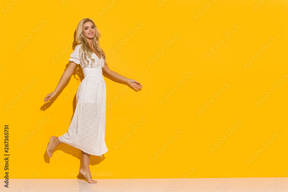 Happy Woman In White Dress Is Walking Barefoot In The Sunlight Happy Woman In White Dress Is Walking Barefoot In The Sunlight