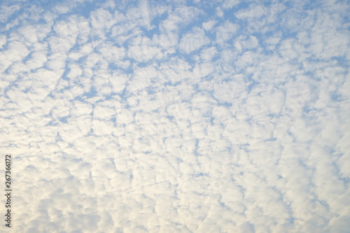 Pattern of white small clouds on bright blue sky