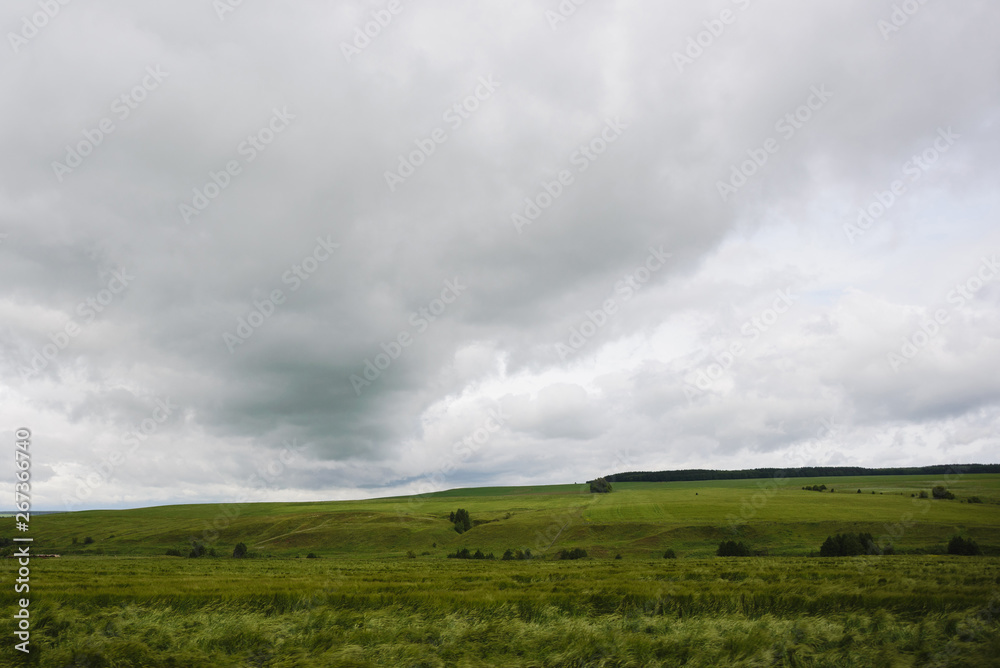 bad weather in summer, dramatic rainy sky clouds over agricultural rural landscape, stock photo image bad weather in summer, dramatic rainy sky clouds over agricultural rural landscape, stock photo image