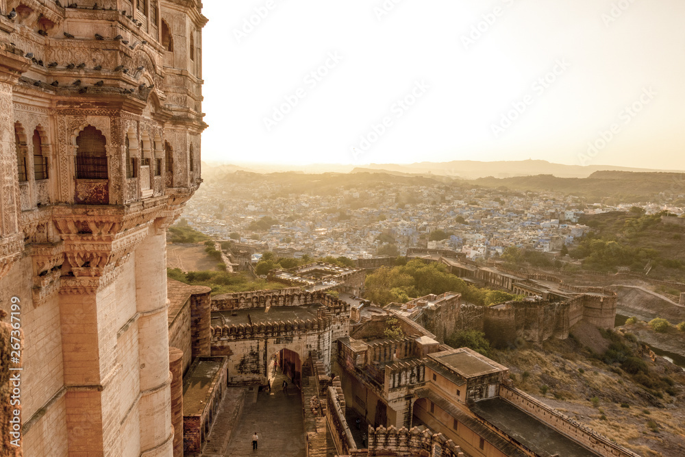 Stunning view of the ancient Mehrangarh Fort during a beautiful sunset with the blue city of Jodhpur in the background, Rajasthan, India. Mehrangarh (Mehran Fort) is one of the largest forts in India.