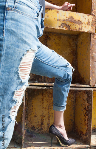 Woman's legs in ragged jeans