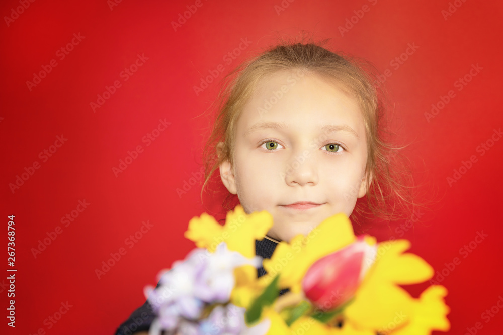 Portrait of a girl with flowers on a red background in the studio close-up. Portrait of a girl with flowers on a red background in the studio close-up.