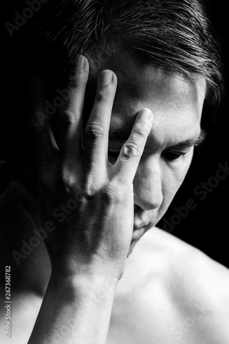 black and white portrait of unhappy asian man, close up