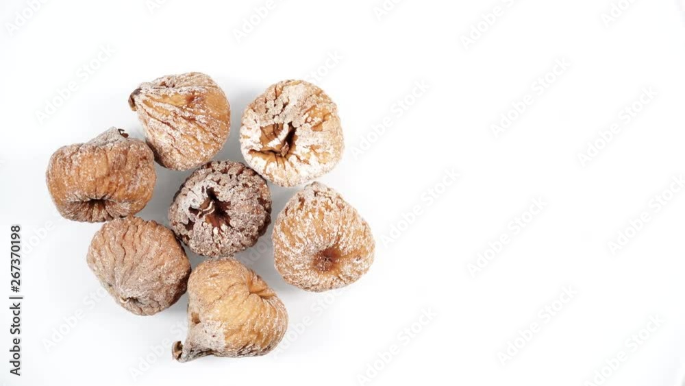 Whole dried fig fruits rotating on white background. Healthy food organic nutrition. Top down view Whole dried fig fruits rotating on white background. Healthy food organic nutrition. Top down view