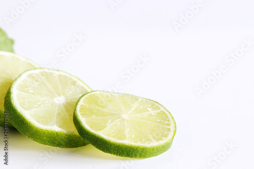 Set of fresh whole and cut lime and slices isolated on white background. From top view. Rich of nutrients, fiber, and vitamins. Picture design for foods background. Delicious fruit .