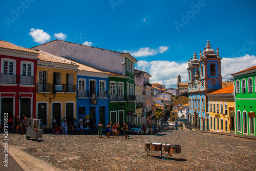 Historic city center of Pelourinho features brightly lit skyline of colonial architecture on a broad cobblestone hill in Salvador, Brazil