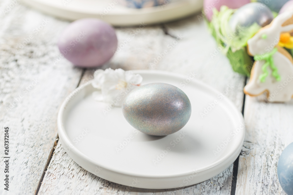 Easter table with Easter eggs over white background Easter table with Easter eggs over white background