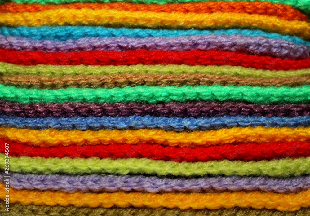 Colorful design background of knitted woolen elements in a pale