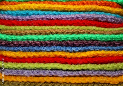 Colorful design background of knitted woolen elements in a pale © lipchania