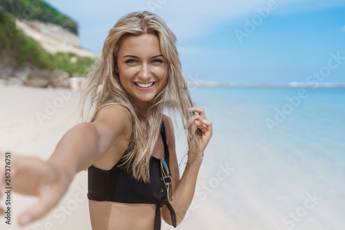Let swim together. Charming romantic carefree woman hold your hand turn camera smiling laughing happily, ask follow me, couple lovely strall seaside, sandy beach ocean shore enjoy summer travelling