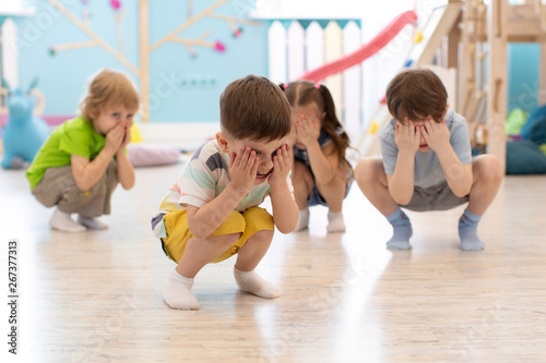 Group of children squatting...